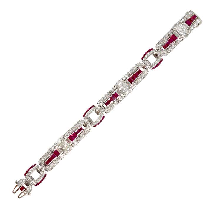 Art Deco diamond and ruby strap bracelet by Raymond Yard Inc., New York, spaced by three principal oval cut diamonds,